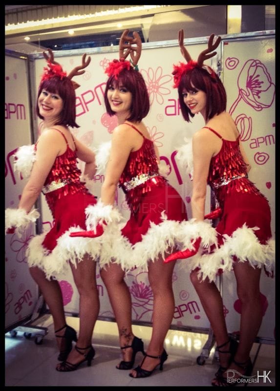 Three reindeer girl dancers in Hong Kong posing at the APM shopping mall Christmas event