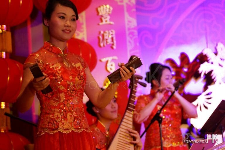 Three Hong Kong Chinese music musicians playing Chinese traditional instrument Bamboo Castanet , Pipa and Xiao at a New year event