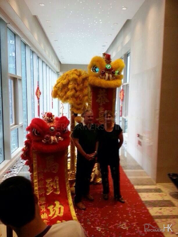 Two couple in Hong Kong taking picture with two lion after the Lion dance