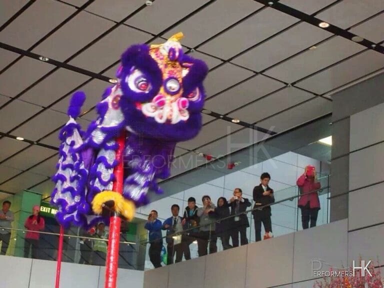 Performer in HK performing Lion Dance with purple lion costume  at a shopping mall event