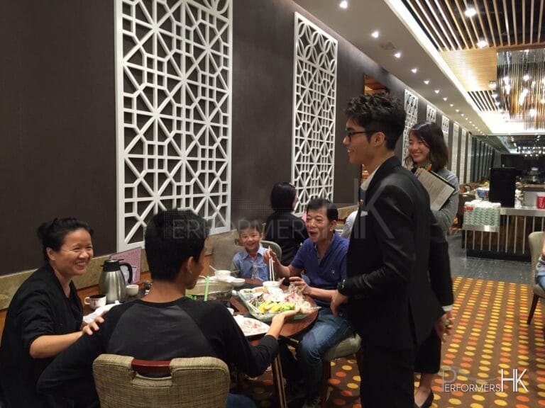 Magician in Hong Kong performing roving table magic for a family to promote the new menu at a restaurant