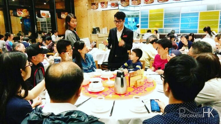 Walk around magician performing table magic for a family to promote the new menu at a Hong Kong restaurant