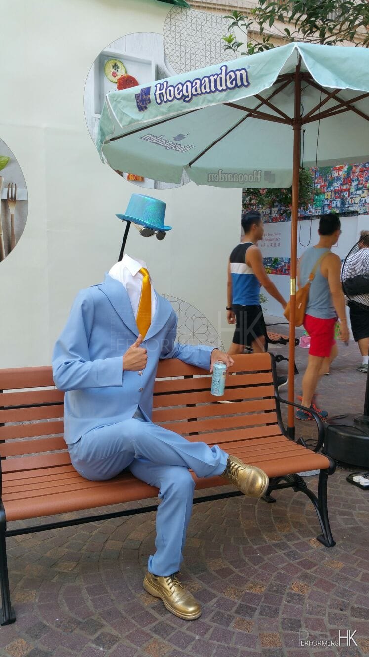 Hong Kong living statue performer in headless man costume at Lee Tung Avenue.