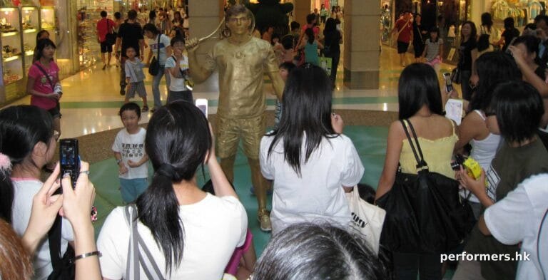 Living statue tennis player performing in the mall