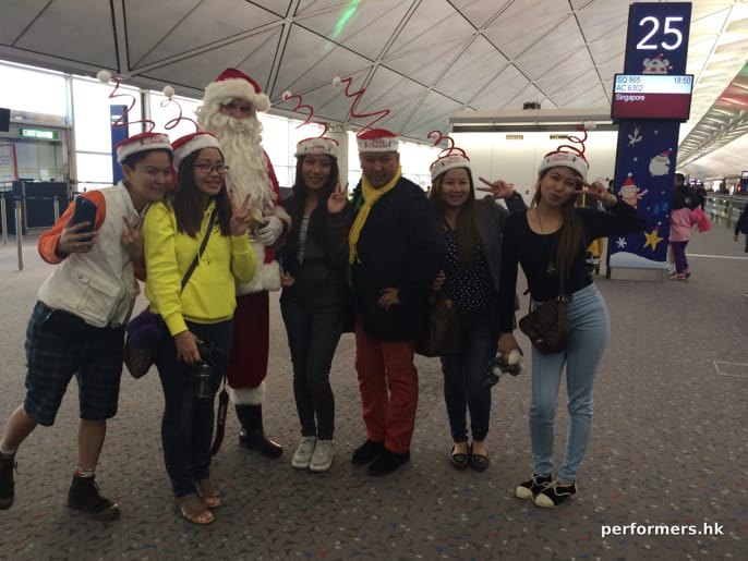 Santa at airport with guests in different clothes
