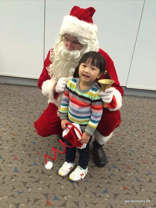 red santa costume with young girl at the airport