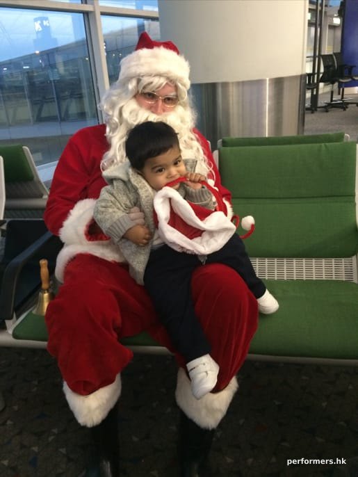 kid sitting on Santas lap at the airport