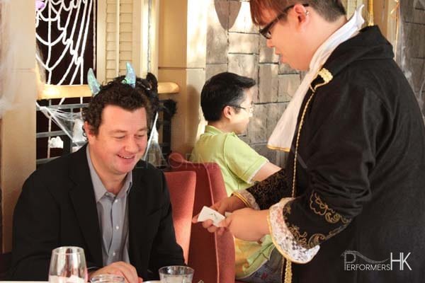 Magician in Hong Kong dressed up in regal costume performing walk around magic