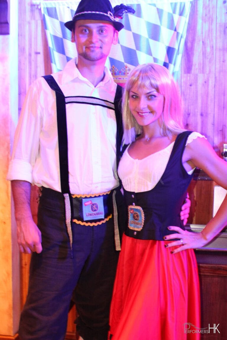 Bavarian dance duo poses at Jockey Club Oktoberfest event in Hong Kong