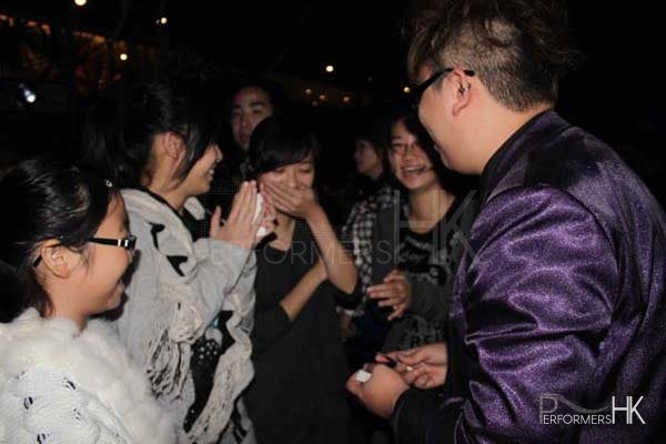 Magician performing roving magic to four girls at a Hong Kong Bank corporate cocktail event.