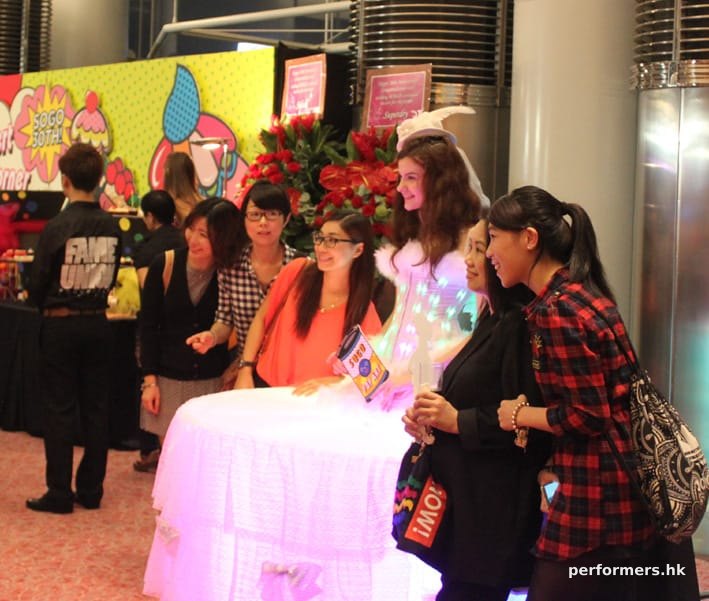 A living table dressed as an angel lit up with LEDS all over her body