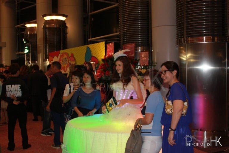A lady dressed as a living table for corportate entetainment having picture taken of her