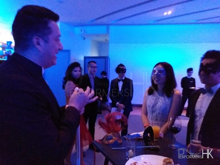 Magician at event with audience members in awe, hong kong sky 100 performance