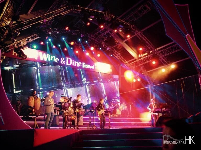 6 piece Band onstage with the banner for the Wine Fair in the background