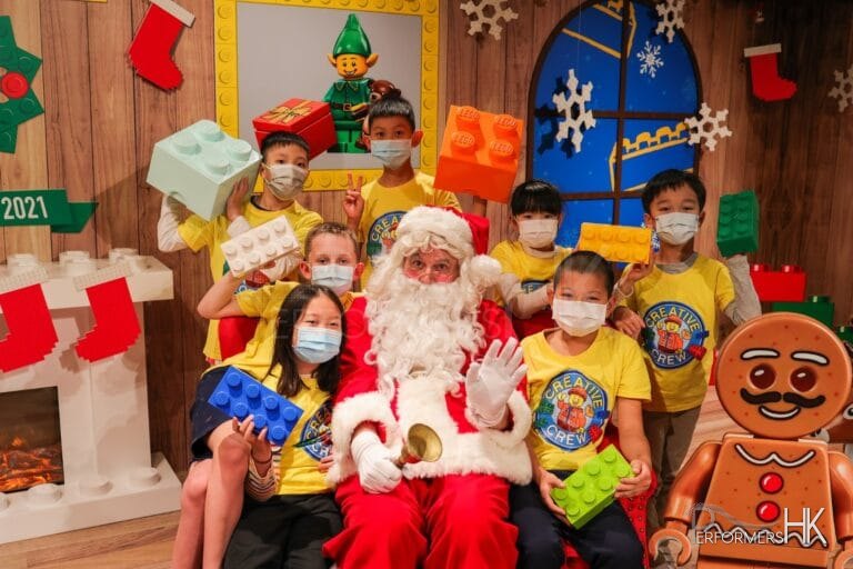 santa in red costme with children wearing yellow tops in tsim tsai tsui in Hong Kong
