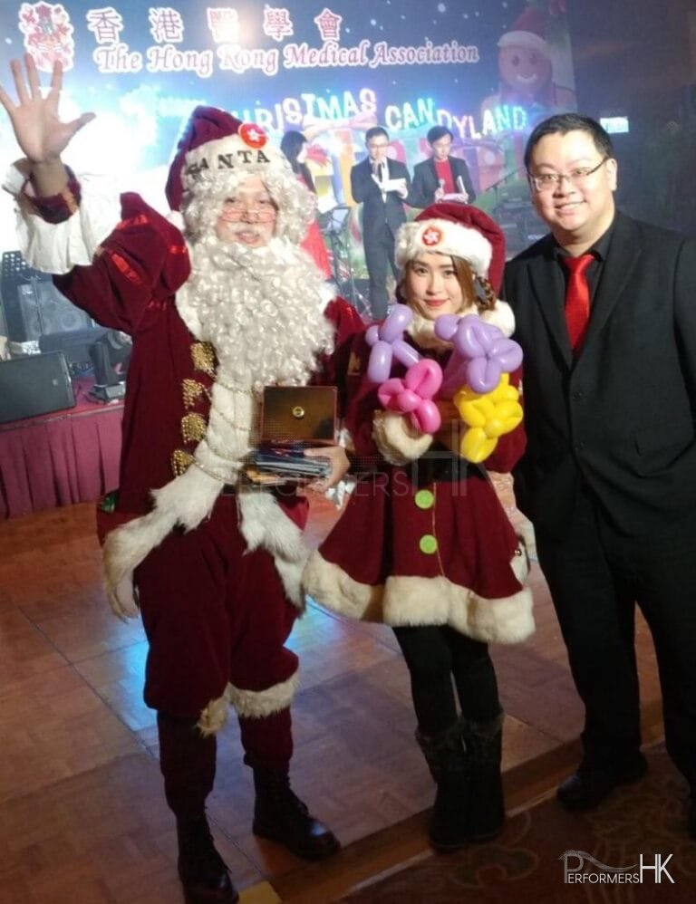 Santa Mario standing with Santa girl with doctor
