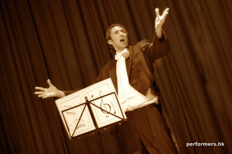 A Kong Kong stage magician performing his comedy musical magic show at a corporate annual dinner