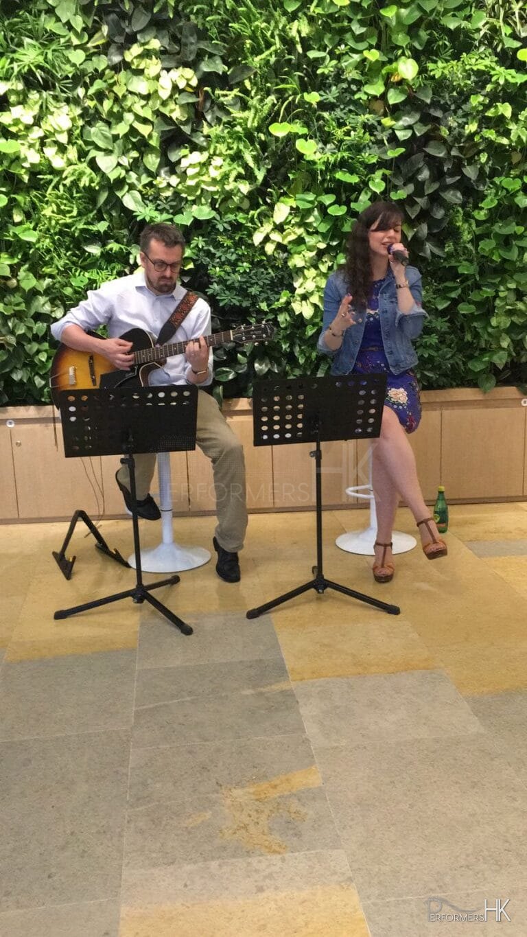 Singer and guitarist performing at Pacific place in Hong kong, casual summer vibe
