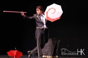 Hong Kong magician performing stage illusion magic with umbrella and wand at corporate annual dinner