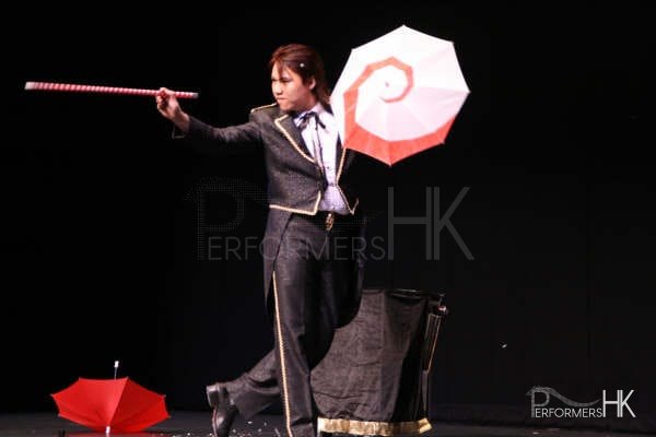 Hong Kong magician performing stage illusion magic with umbrella and wand at corporate annual dinner