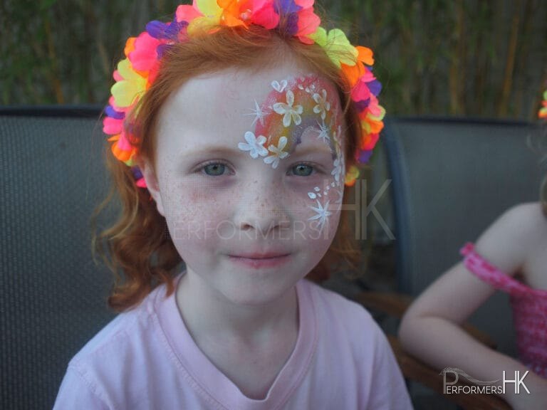 A HK face painter draw a rainbow face paint for a rainbow themed summer party