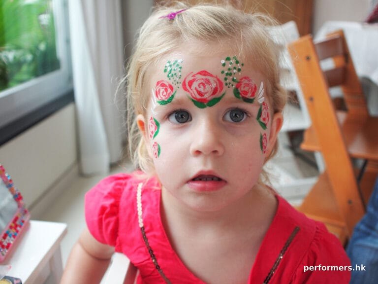 Hong Kong face painter paint a lovely rose crown face paint for a little girl at a children birthday party