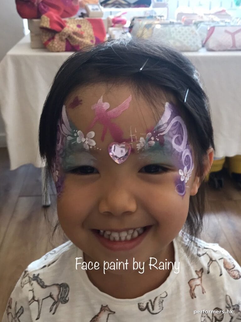 young girl with face painting by rainy