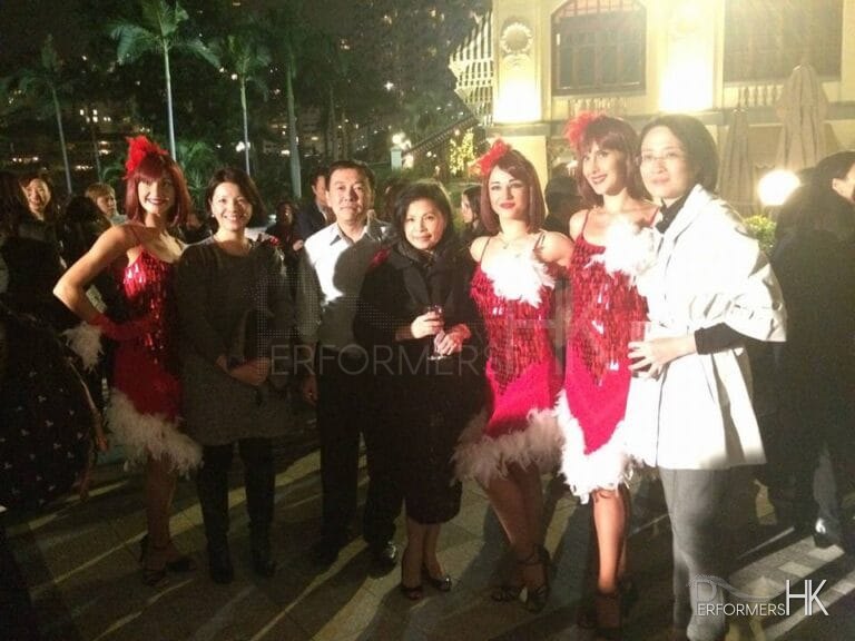 Three Hong Kong Dancers dress as Reindeer girls taking picture with the guests after the dance performance at a corporate Christmas event