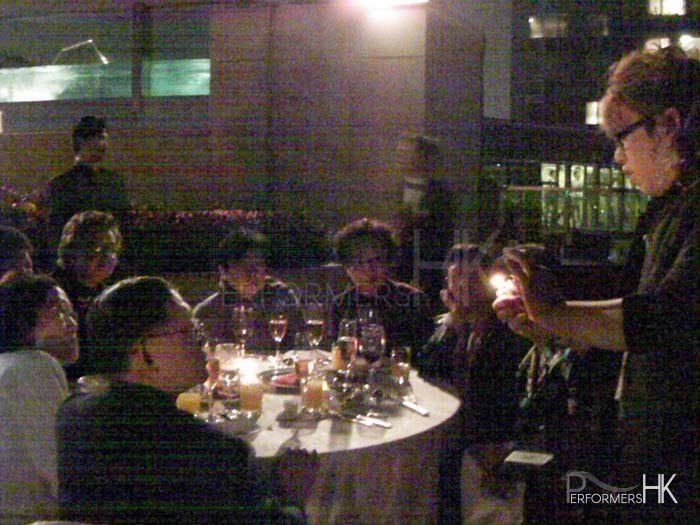 Magician in HK performing roving fire magic in front of a table of guests at a corporate dinner event