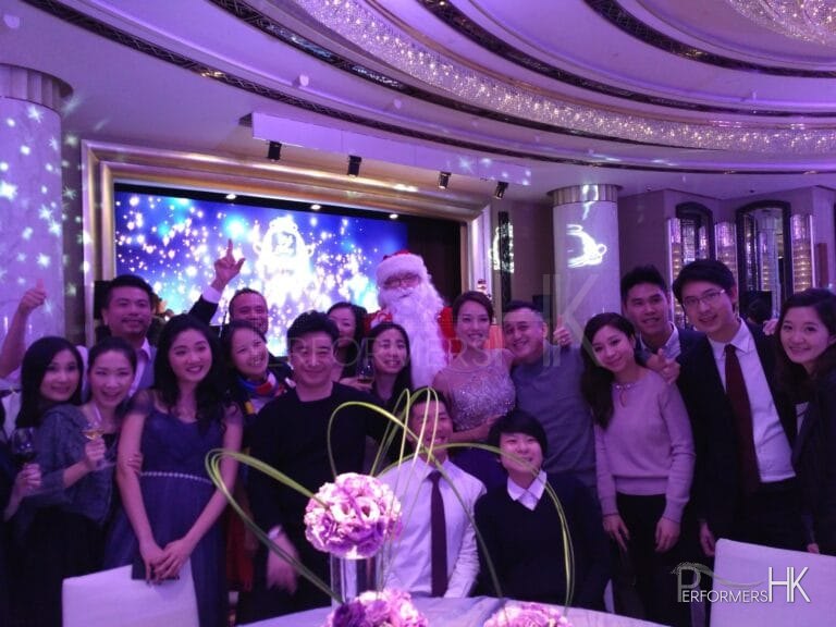 Santa John taking group photos with guests