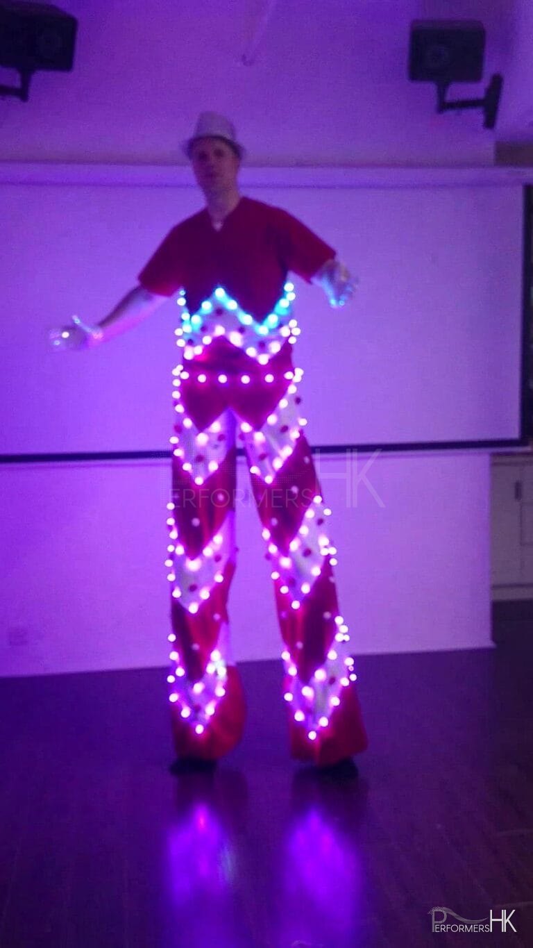 Stiltwalker in a LED costume posting at a studio in Hong Kong