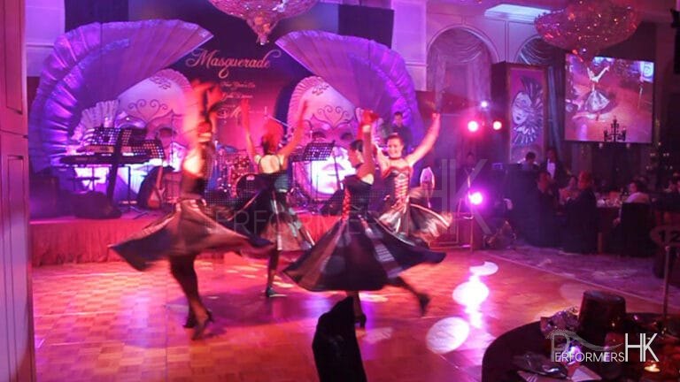 four cancan dancers spinning in circle on dance floor at an event