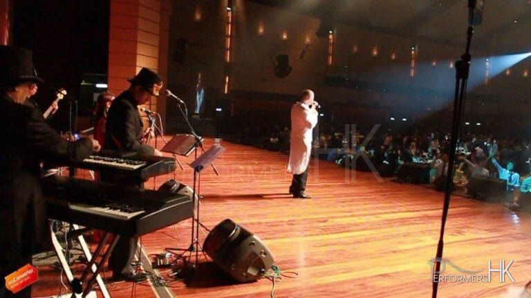 Hong Kong singer performing with a live band on stage at a Annual dinner