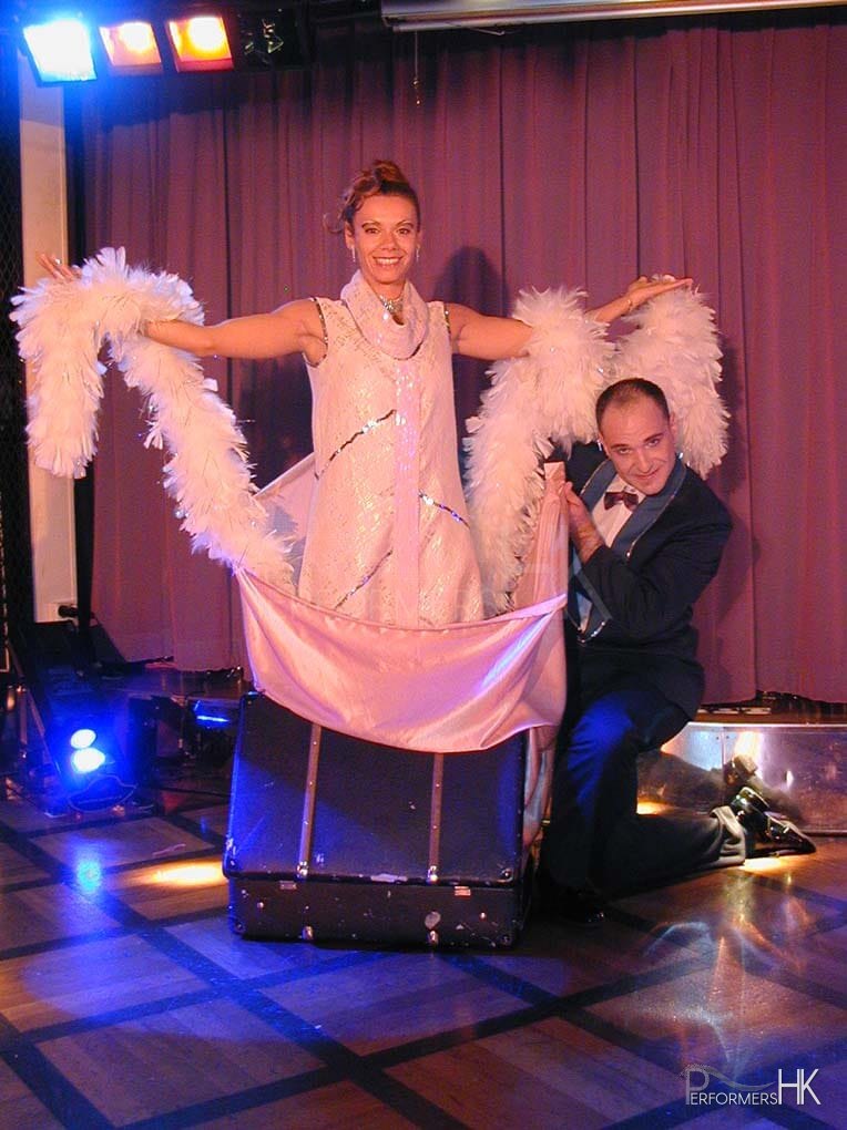 A great performance by a HK magician and his assistant , he is ready to change her dress into a different color for the audience at the Xmas event