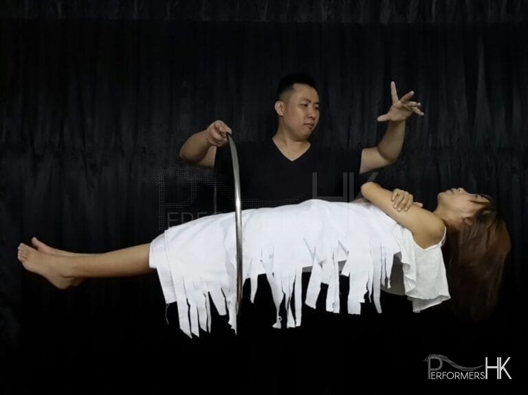 Magician performing large scale illusion trick