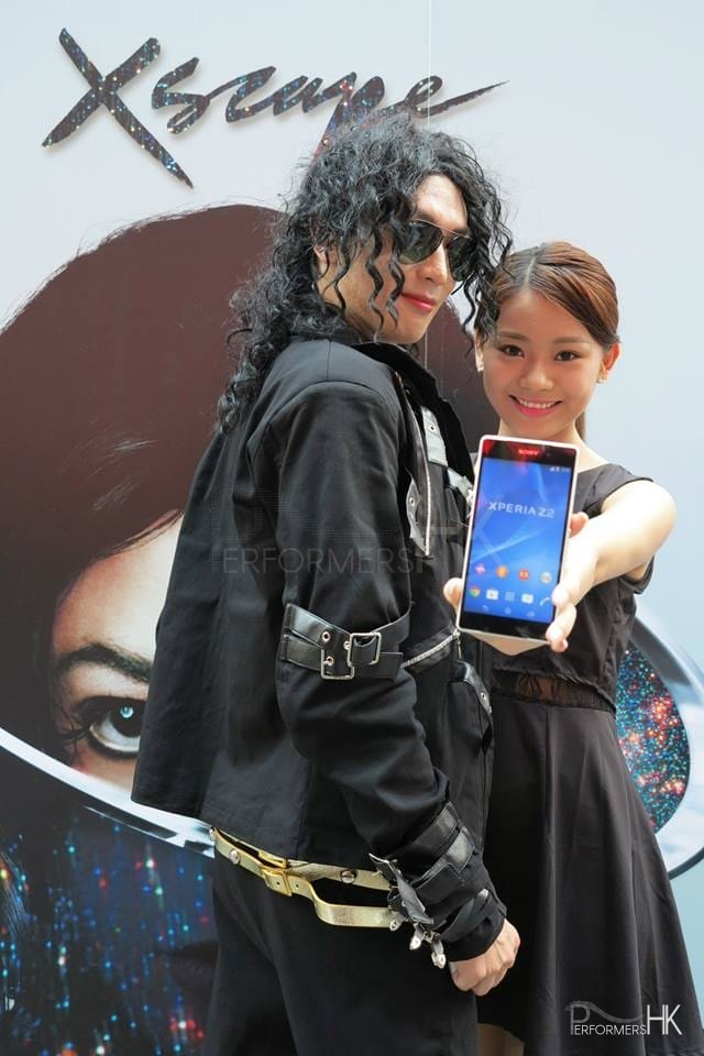 Woman taking selfie with Michael Jackson impersonator