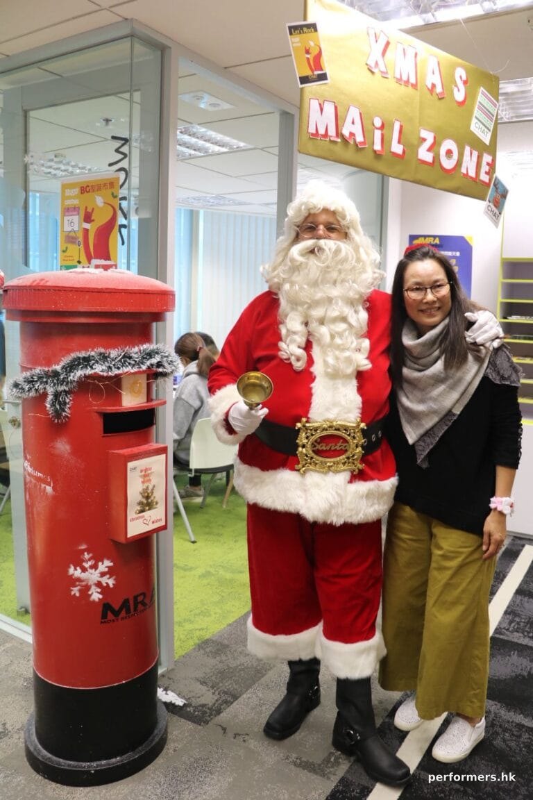 Santa standing next to a Xmas post box