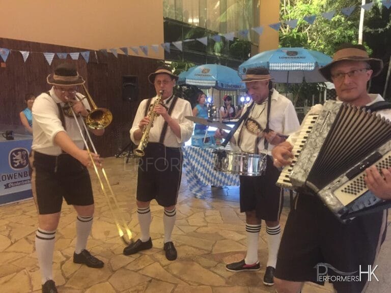 German band in full gear including clarinet, trombone, drums and accordion player