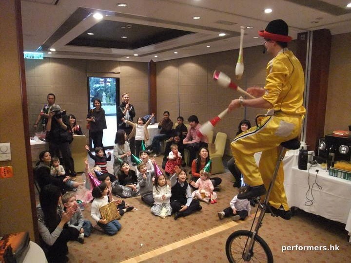 Hong Kong Unicyclist performing three cups juggling on the unicycle at a Family day event