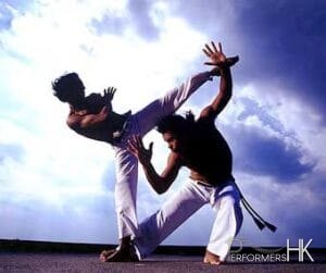 Two male doing Brazilian martial arts