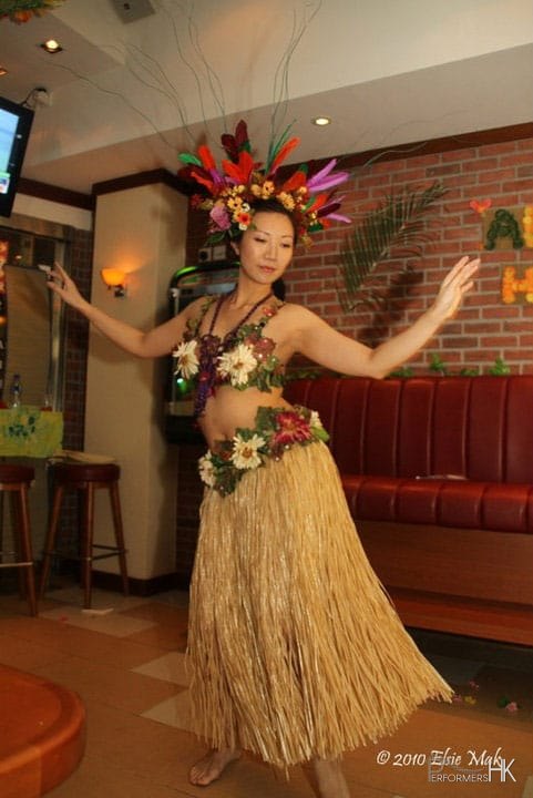 Hong Kong hula dancer performing traditional hula dance, wearing beautiful headpiece