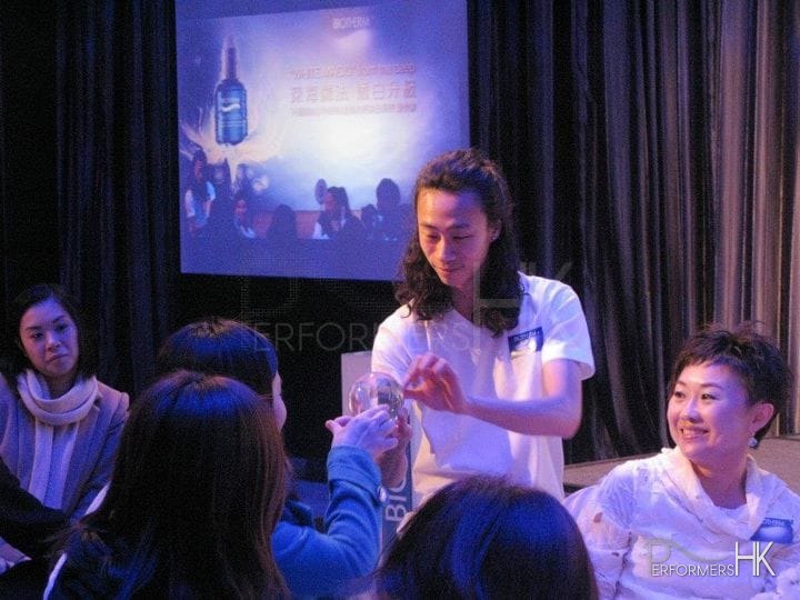 Hong Kong contact juggler performing to a client at a Biotherm product launch event