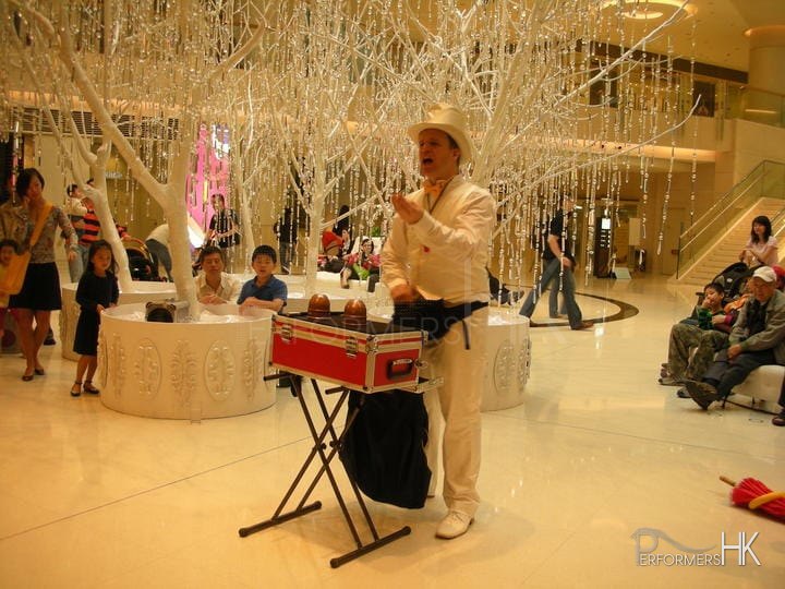HK magician performing roving magic at a corporate event at festival walk