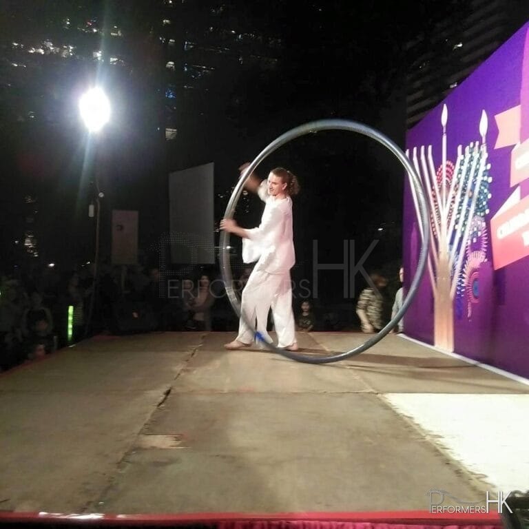 A Hong Kong acrobatics artist performing with wheel at a Hong Kong Xmas corporate event