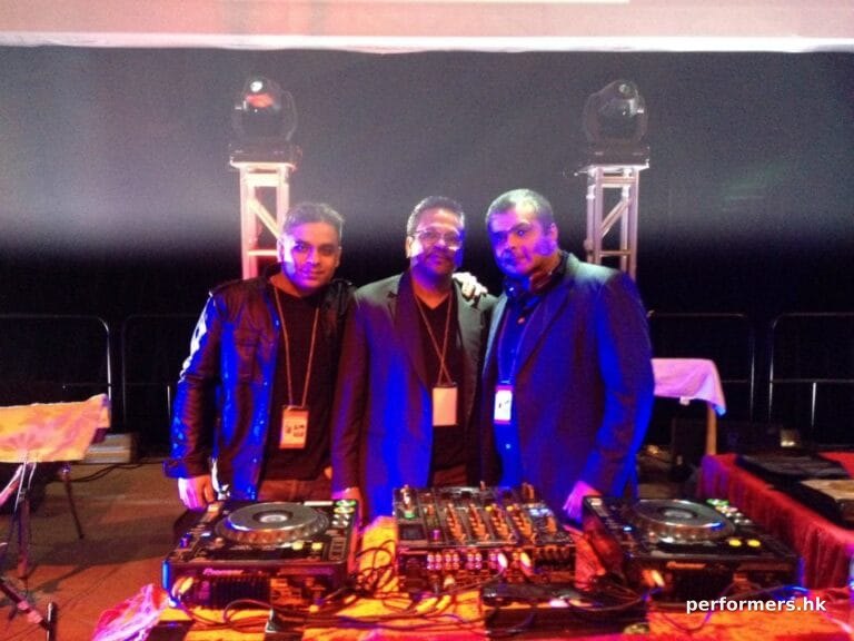 DJ V and two men take picture in Hong Kong