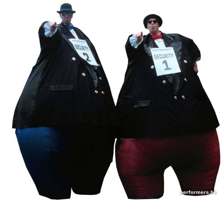 Two HK stilt walker in inflatable giant security guard costumes