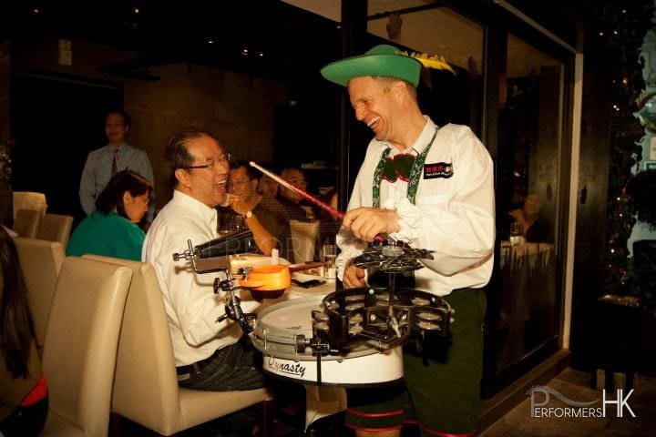 Drummer performing in restaurant, laughing with guests