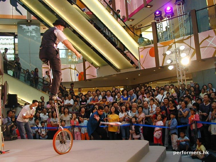 Performing riding a giraffe unicycle for a shopping centre show in SOGO hong kong