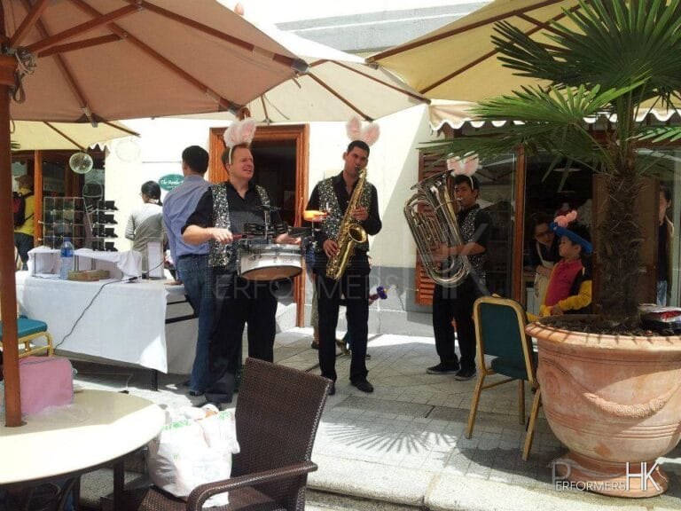 Three roving band musicians performing at a corporate Ester event in Hong Kong