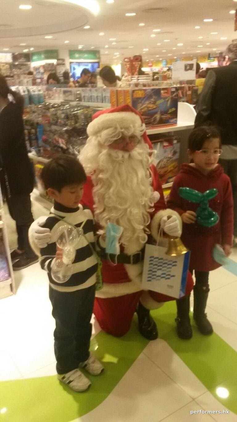 Santa in Hong Kong department store taking photos with children